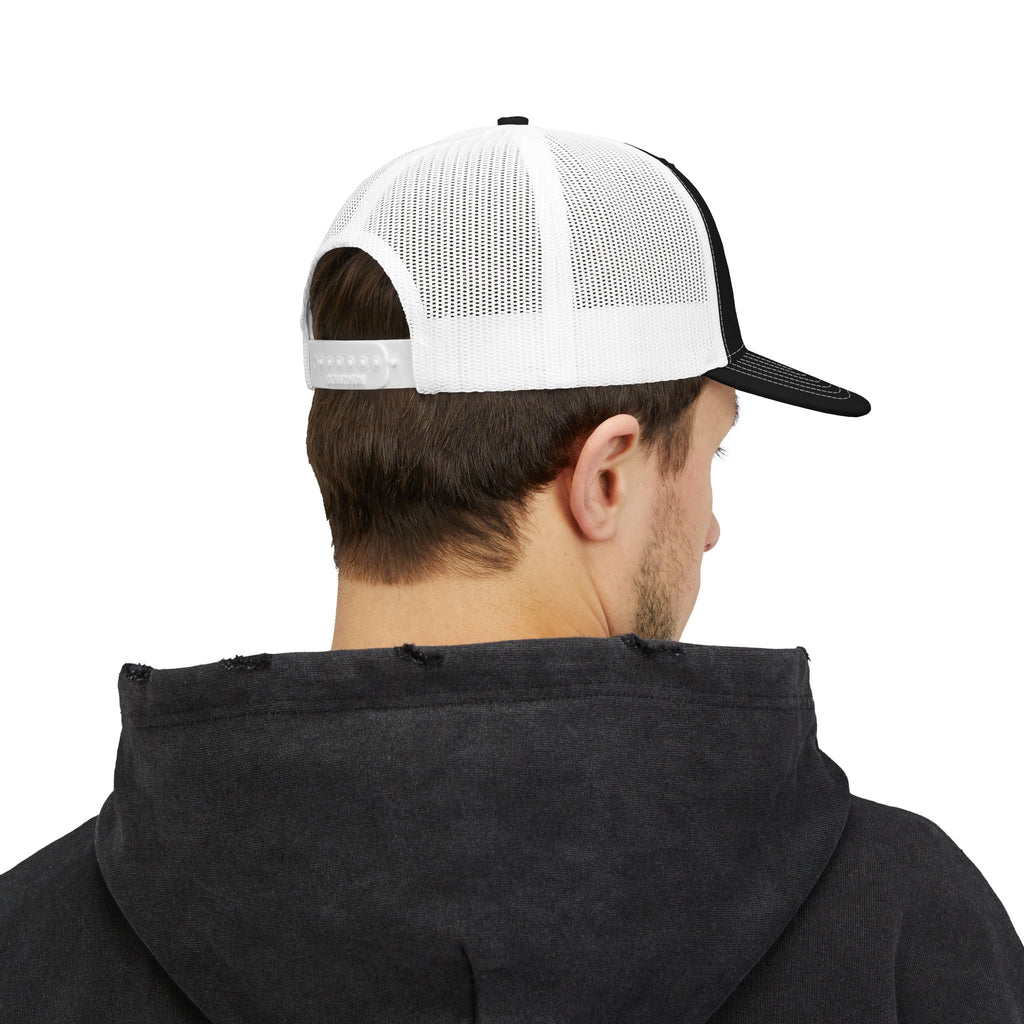 Person wearing a black hoodie and white and black cap on a white background