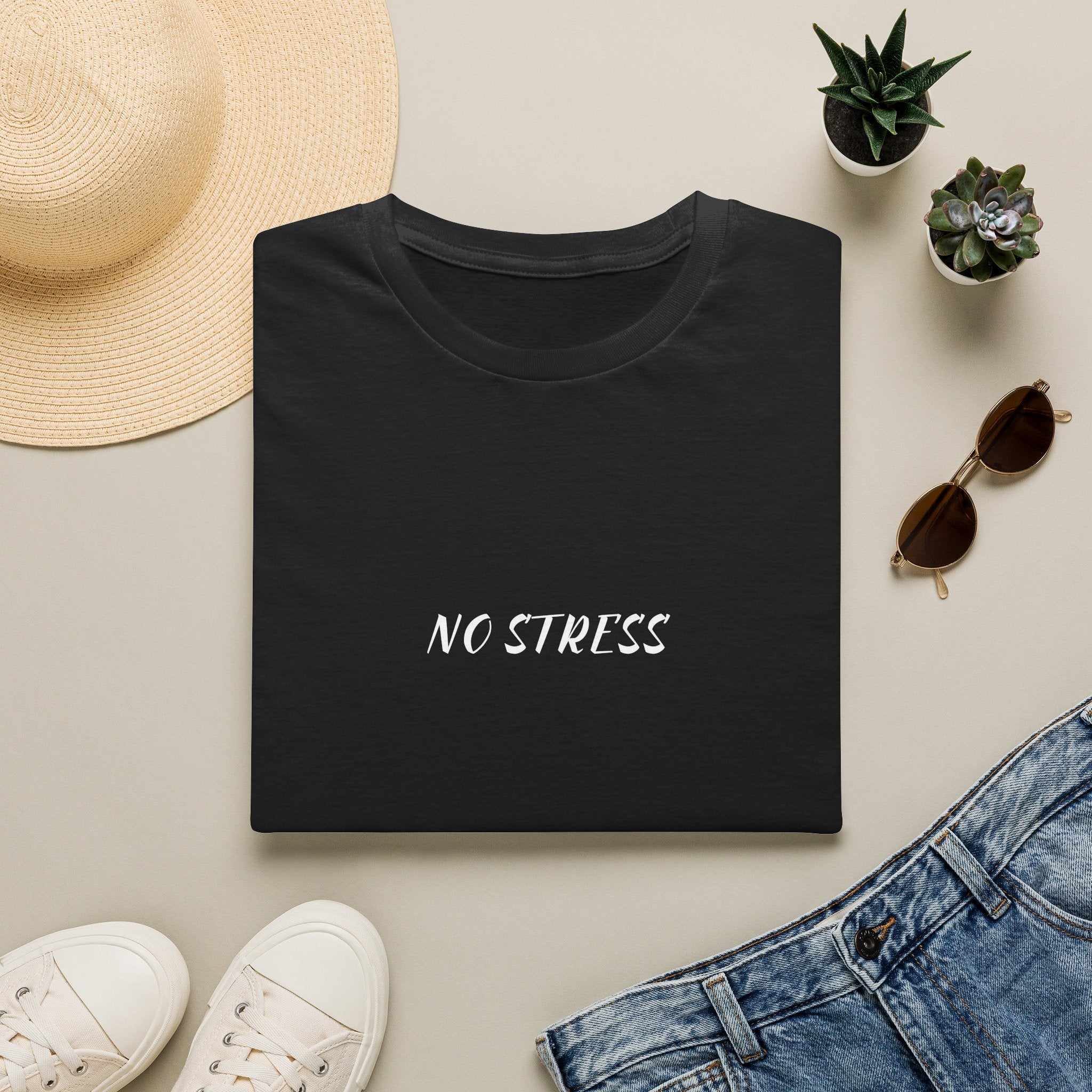 Black t-shirt with 'CEO OF TRUST ME BRO CAPITAL' text on a light surface with casual items.