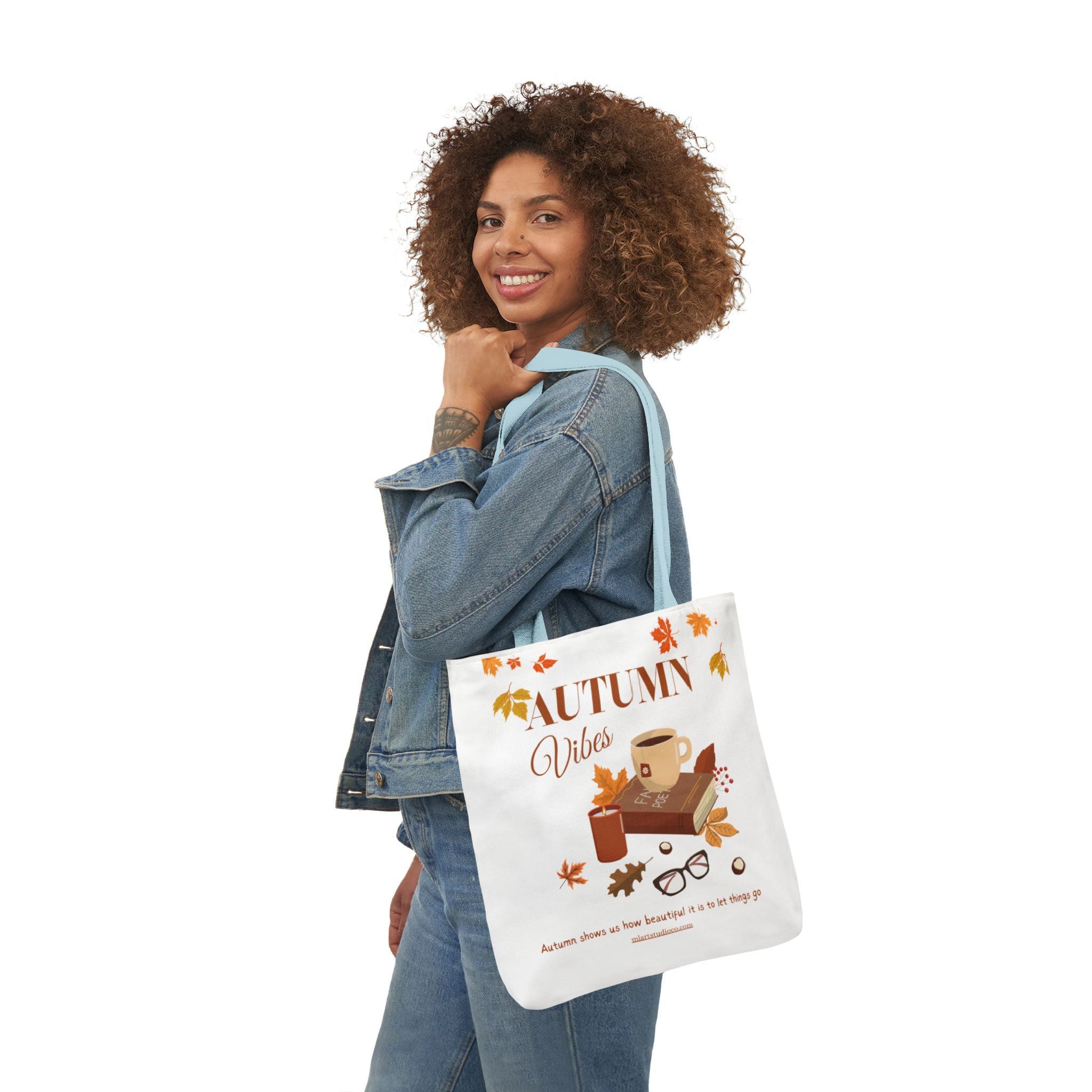 Woman holding a tote bag with 'Autumn Vibes' design on a white background