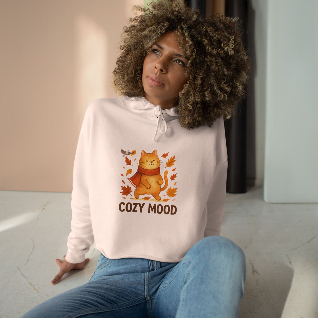 Person wearing a white hoodie with a cat graphic and 'Cozy Mood' text, sitting indoors.