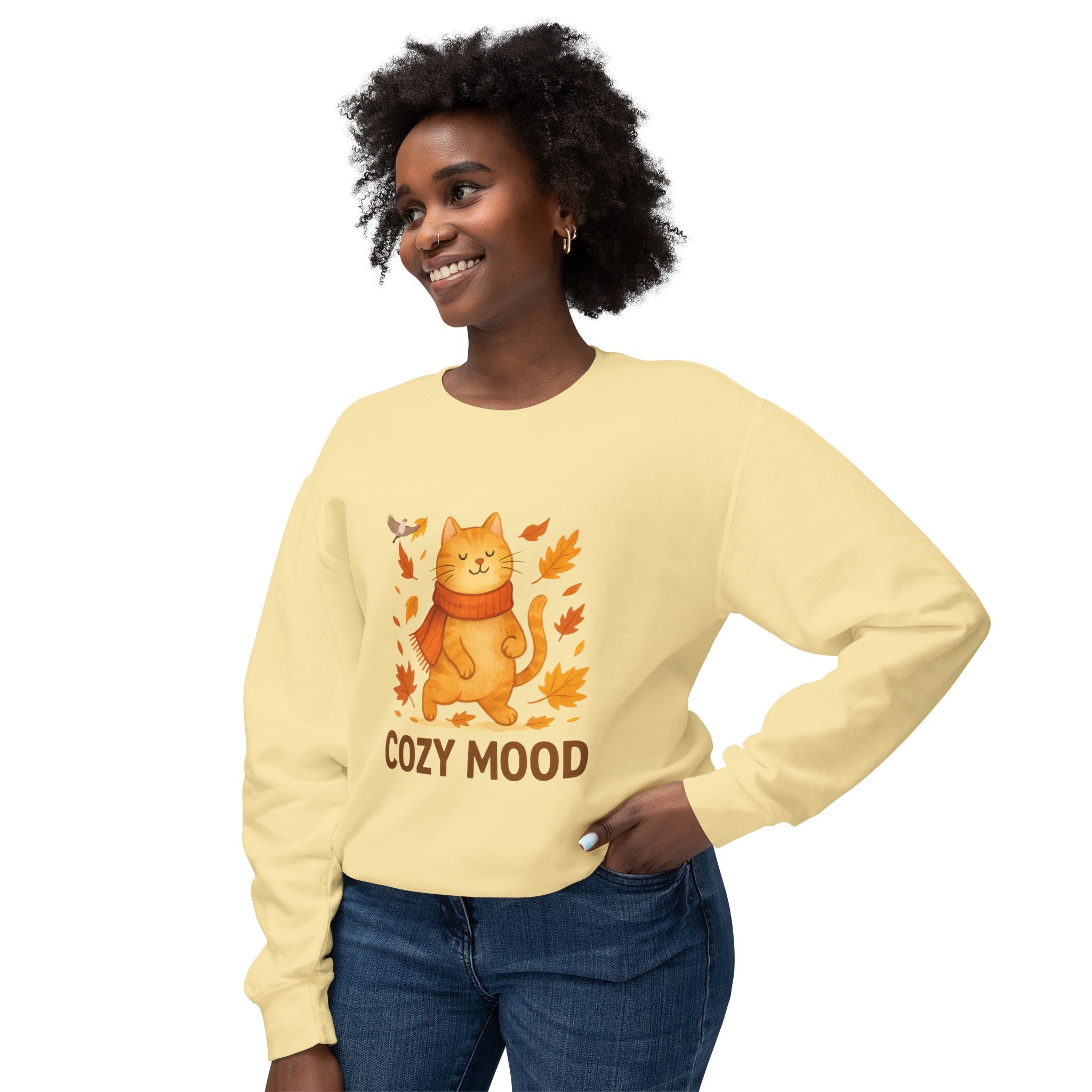 Woman wearing a yellow sweatshirt with a cat graphic and 'Cozy Mood' text on a white background