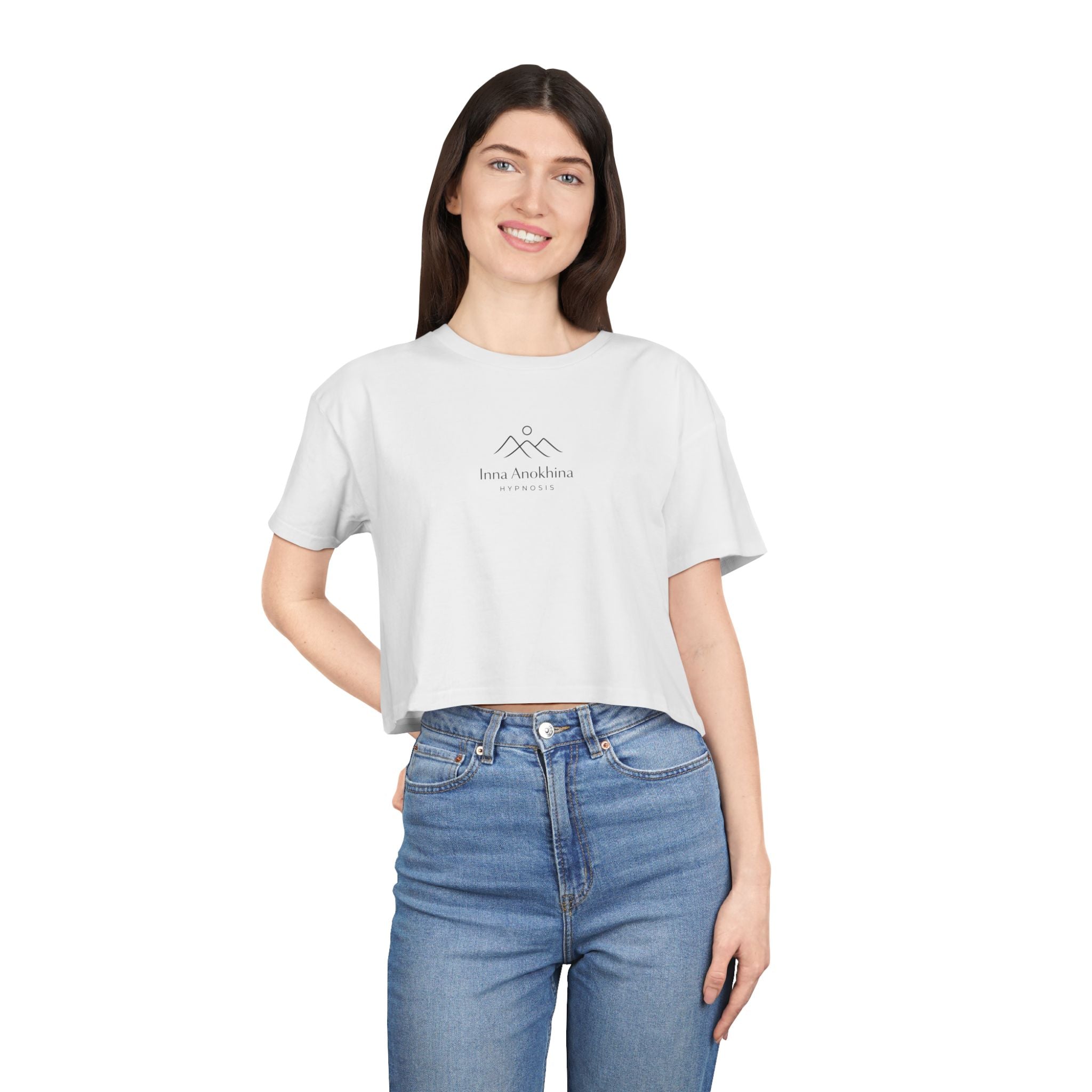 Woman wearing a white t-shirt with a logo and blue jeans on a white background