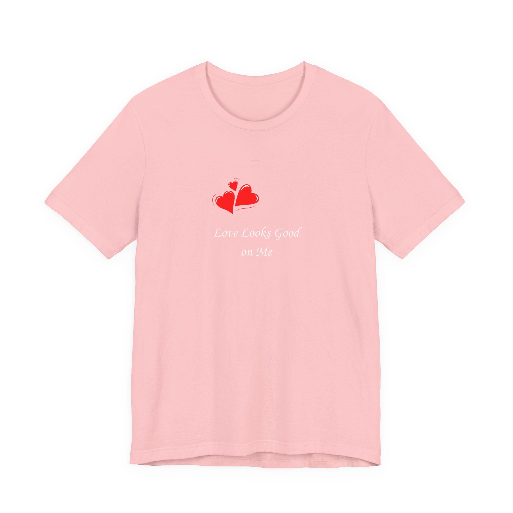 Pink t-shirt with red heart design and text on a white background