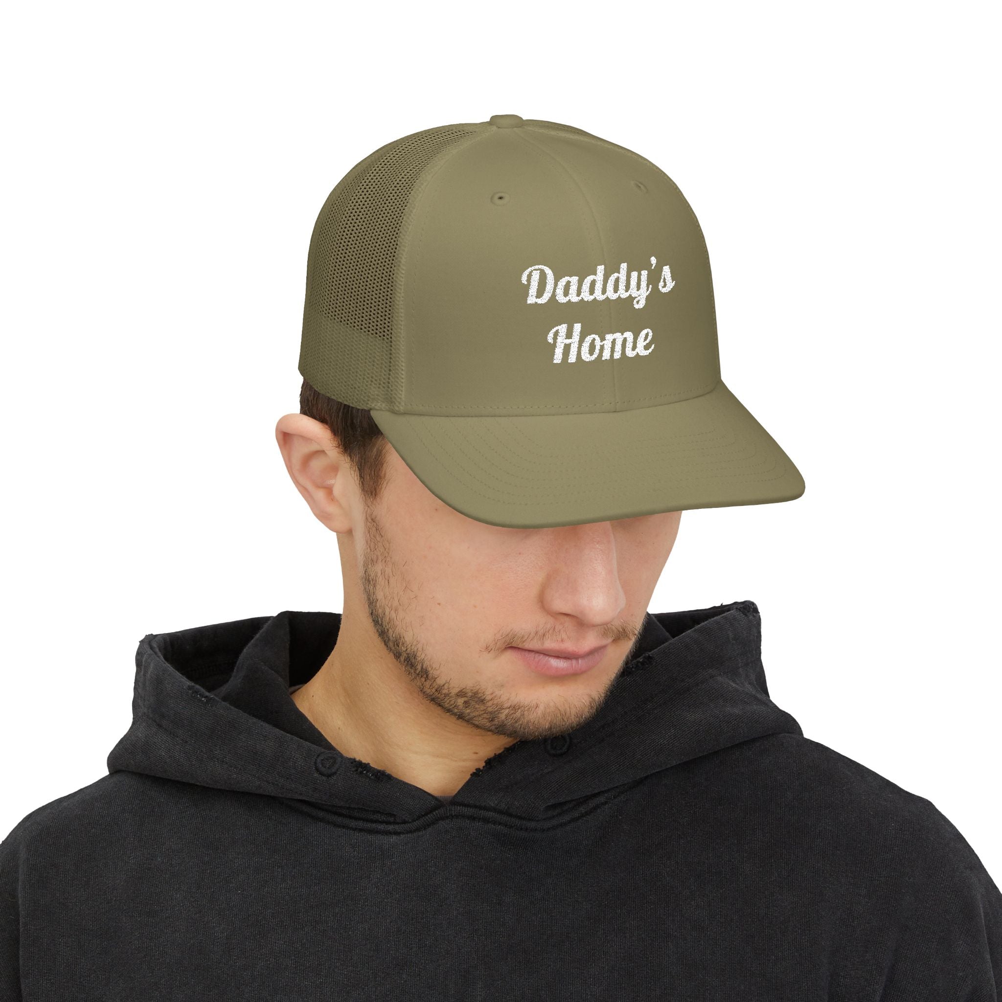 Man wearing a green cap with a logo on a white background