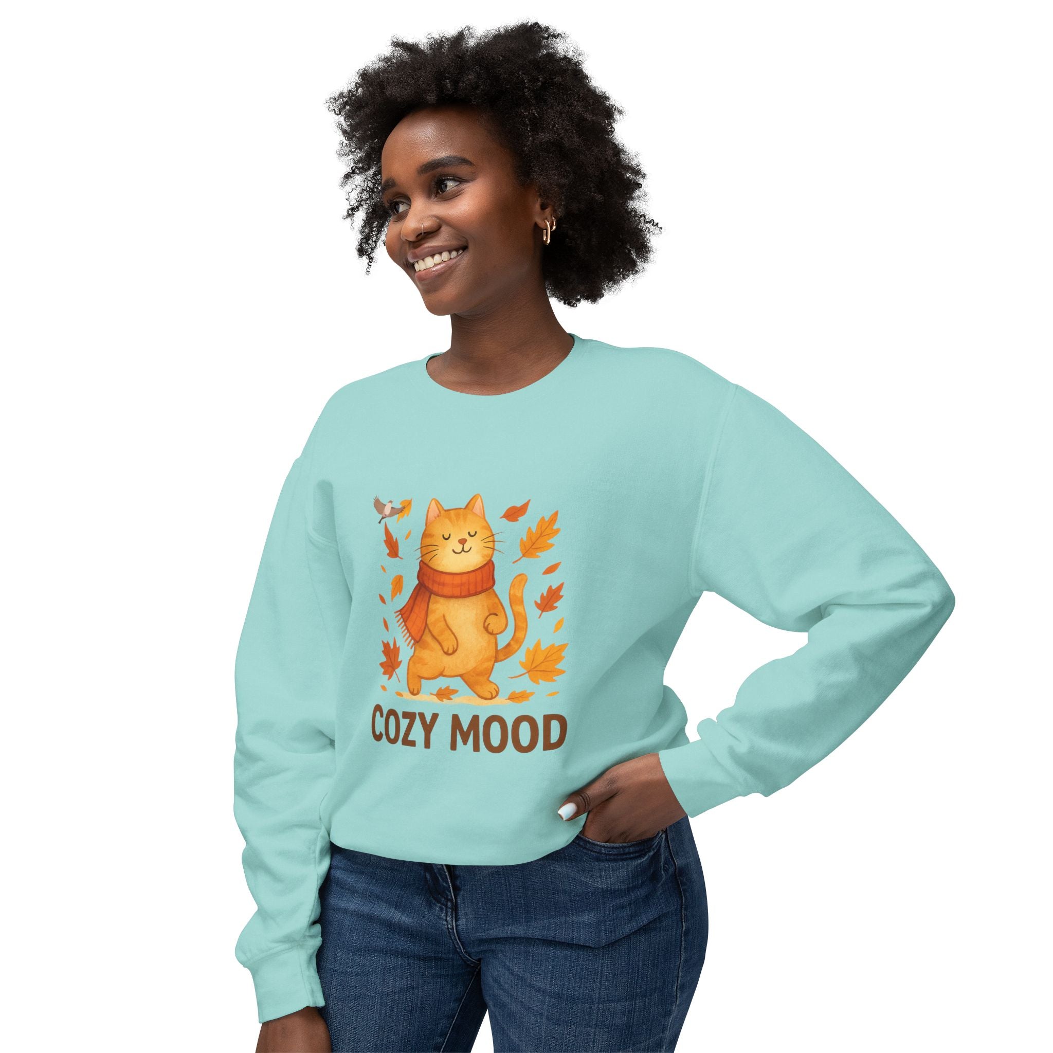 Woman wearing a light blue sweatshirt with a cat graphic and 'Cozy Mood' text on a white background