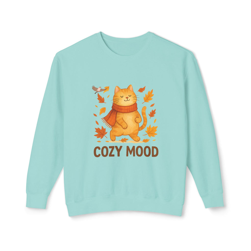 Light blue sweatshirt with a cat wearing a scarf and autumn leaves and the text 'Cozy Mood' on a white background.