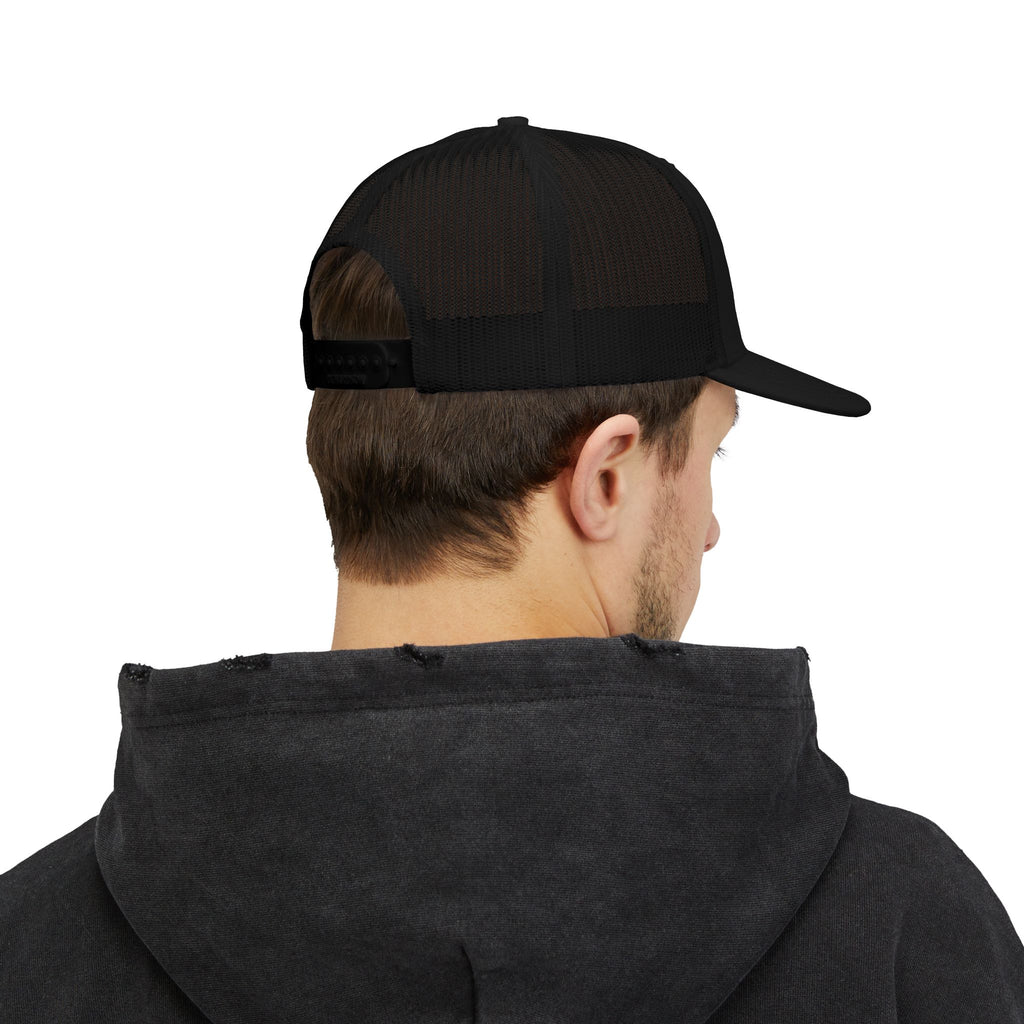 Person wearing a black cap and dark hoodie on a white background