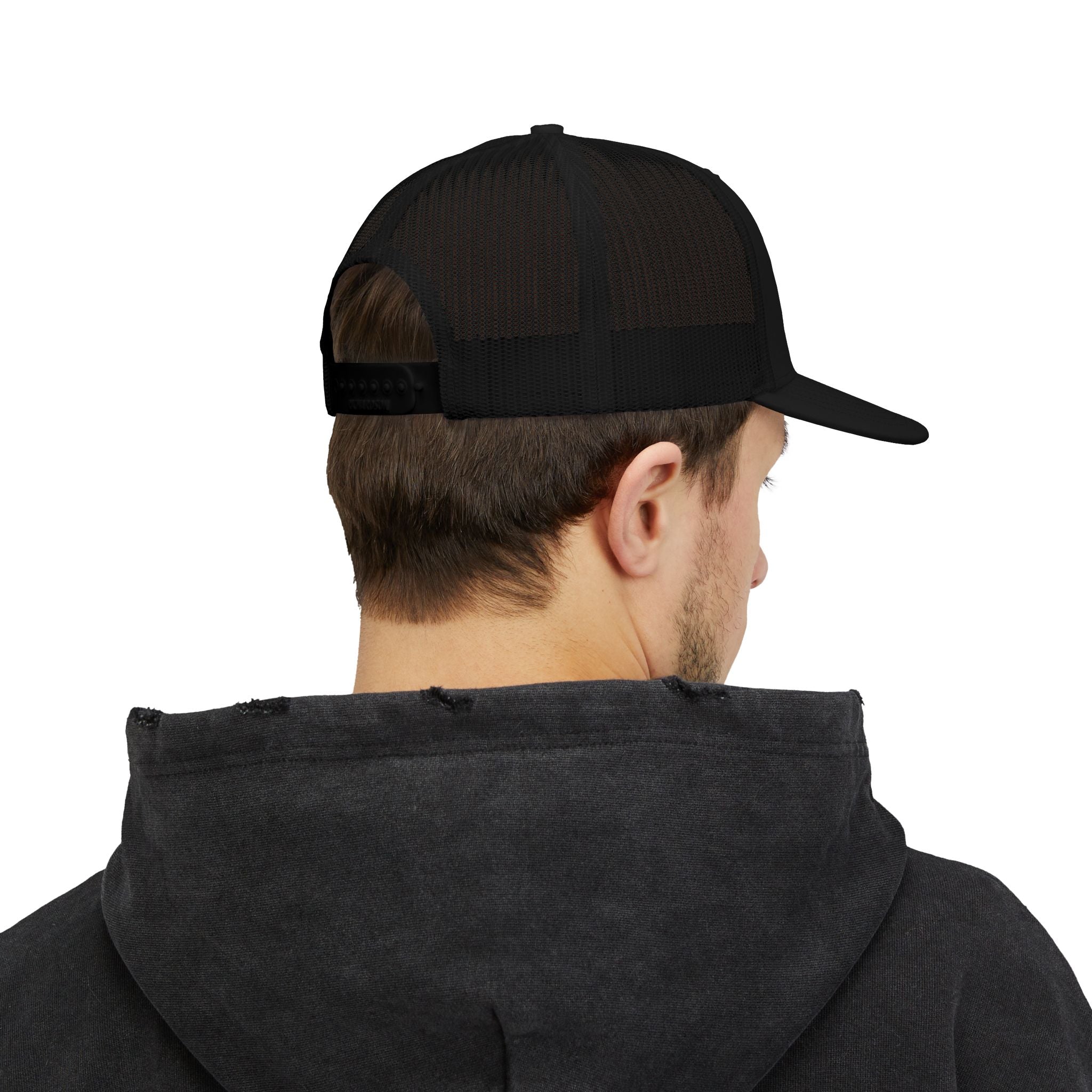 Person wearing a black cap and dark hoodie on a white background