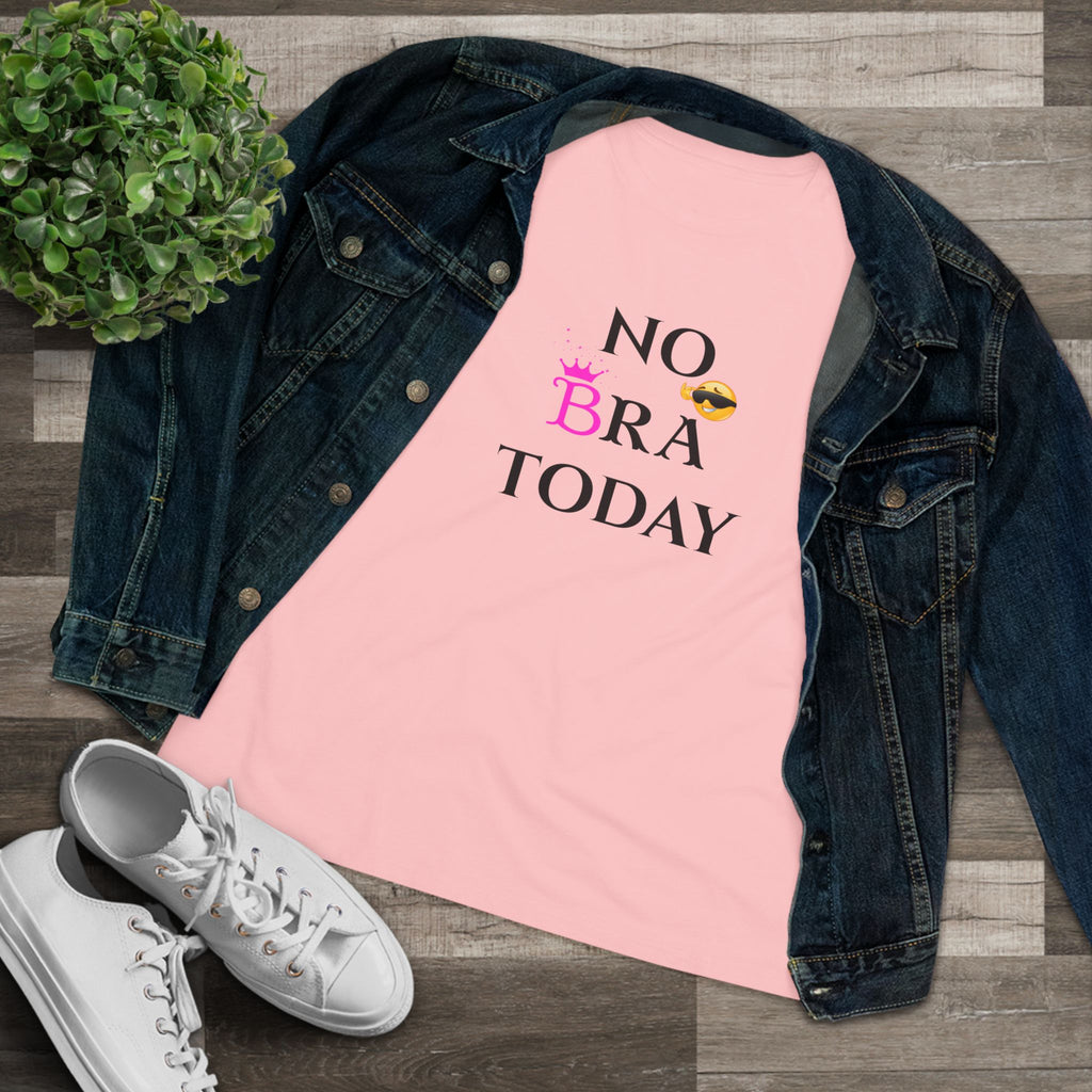 Pink shirt with 'No Bra Today' text, denim jacket, and white sneakers on a wooden floor.
